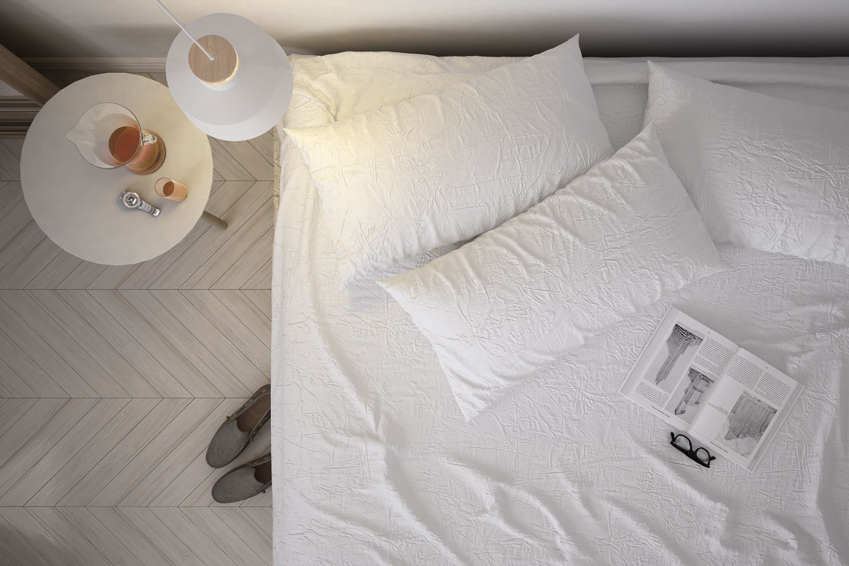 photo of a white bed sheet on the bed pallet wood flooring on the floor of room