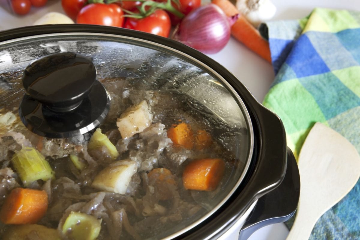 A crock pot slow-cooking a homely beef casserole.