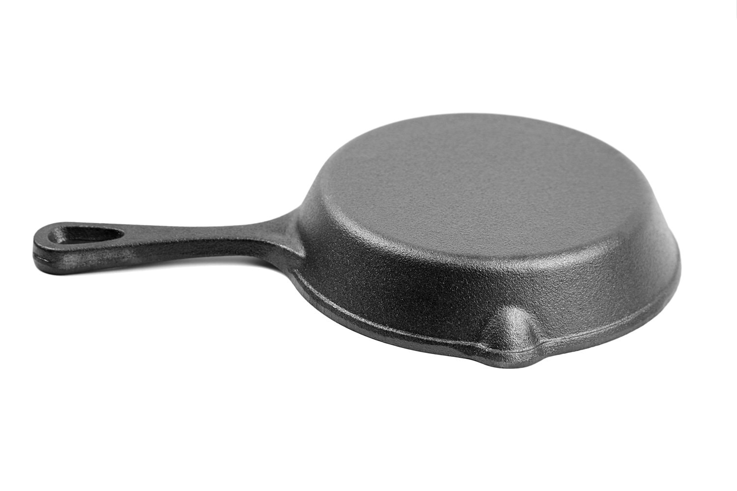 Cast iron pan with handle isolated on white background. One black empty frying skillet bottom, back side. Kitchen equipment, cookware