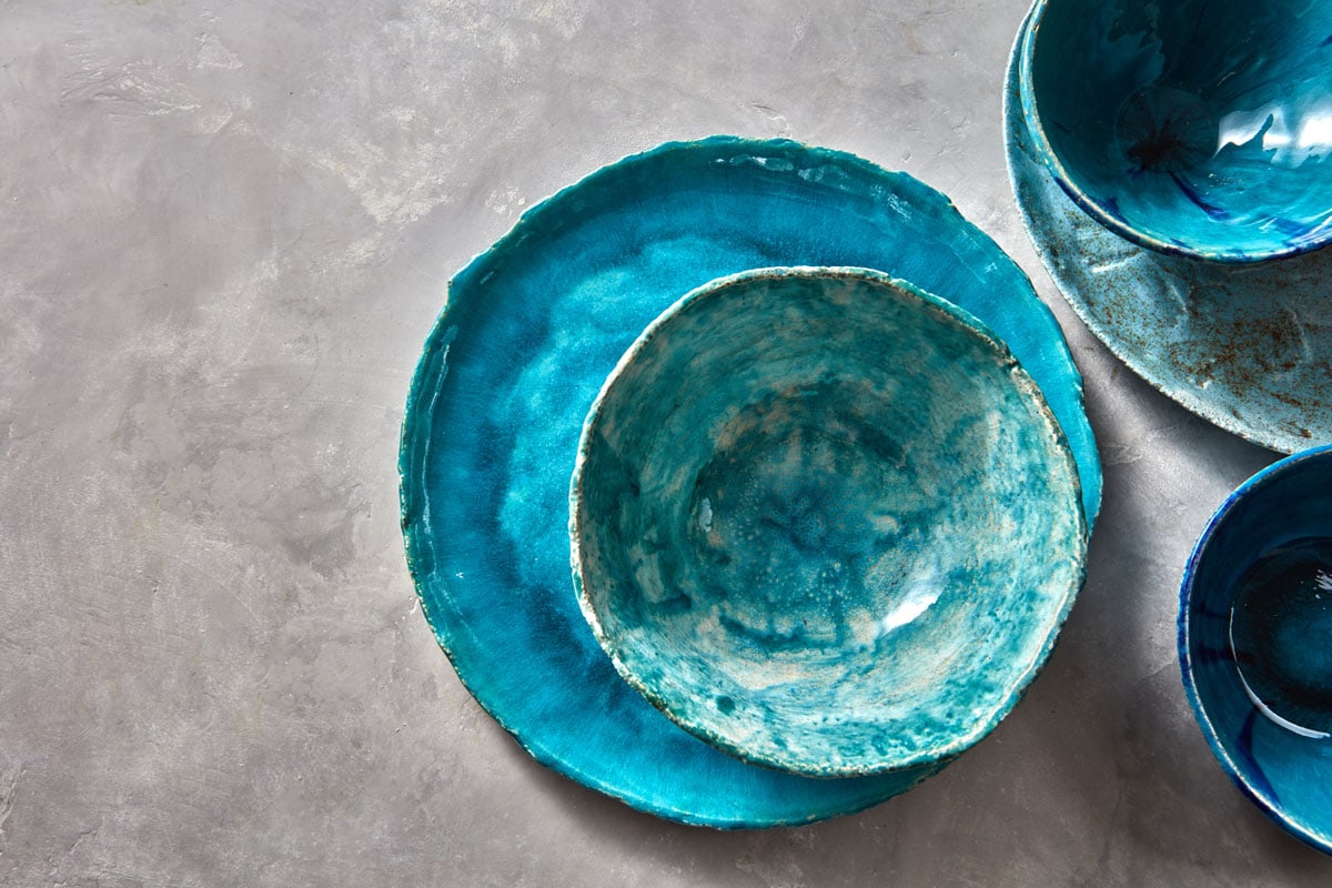 Decorative pottery - bowls, plates covered with glazed on a gray