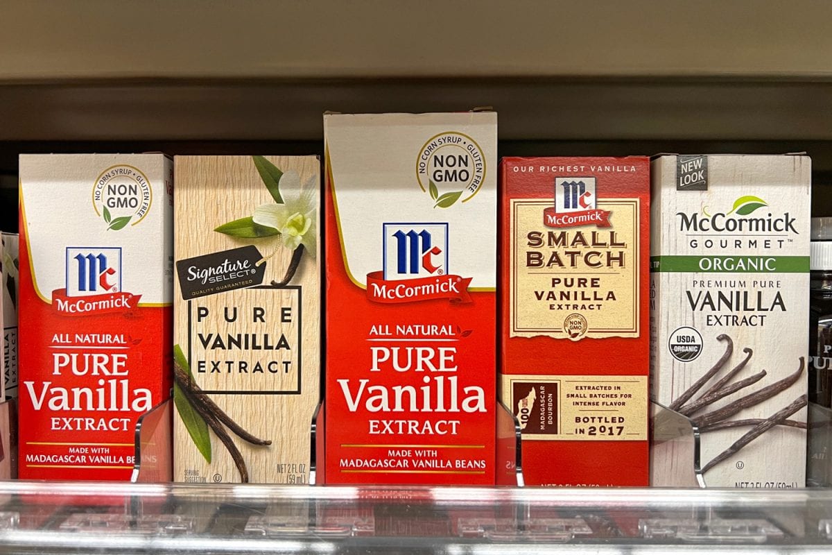 Grocery store shelf with various bottles of pure Vanilla Extract. McCormick's and Signature Select brands.