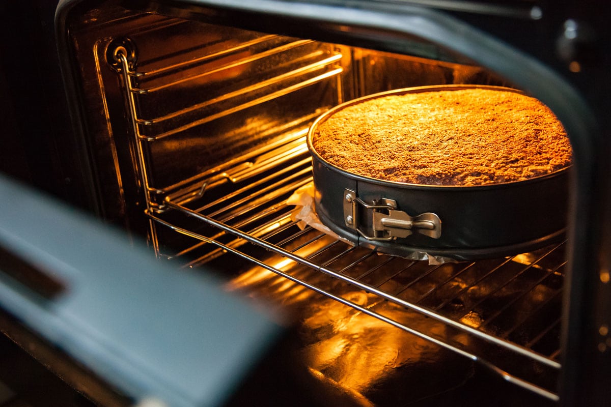Homemade cake is prepared and baked in a special form for baking in an electric oven in the kitchen