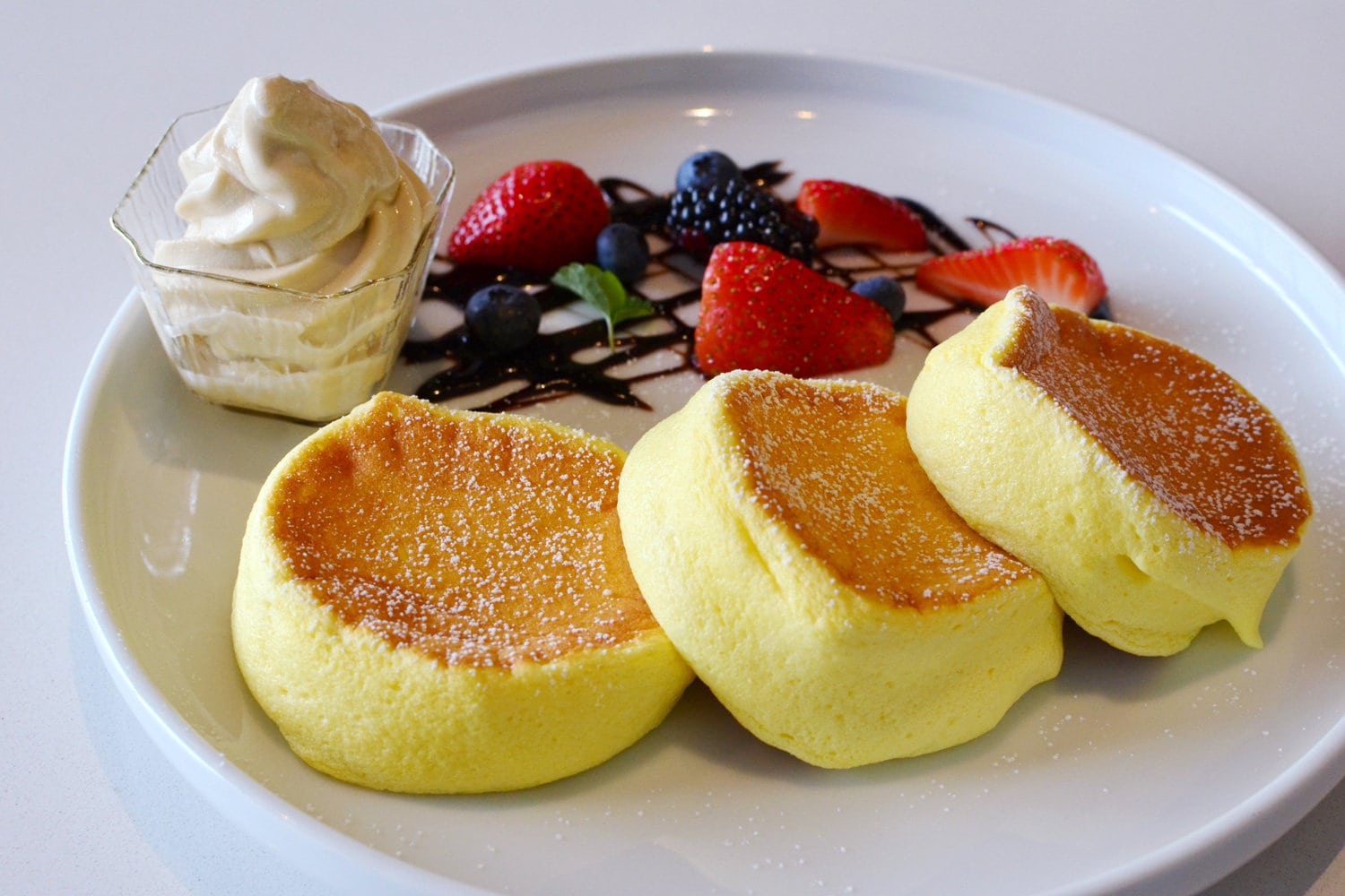 Japanese Souffle Pancakes serve with ice-cream and mixed berries