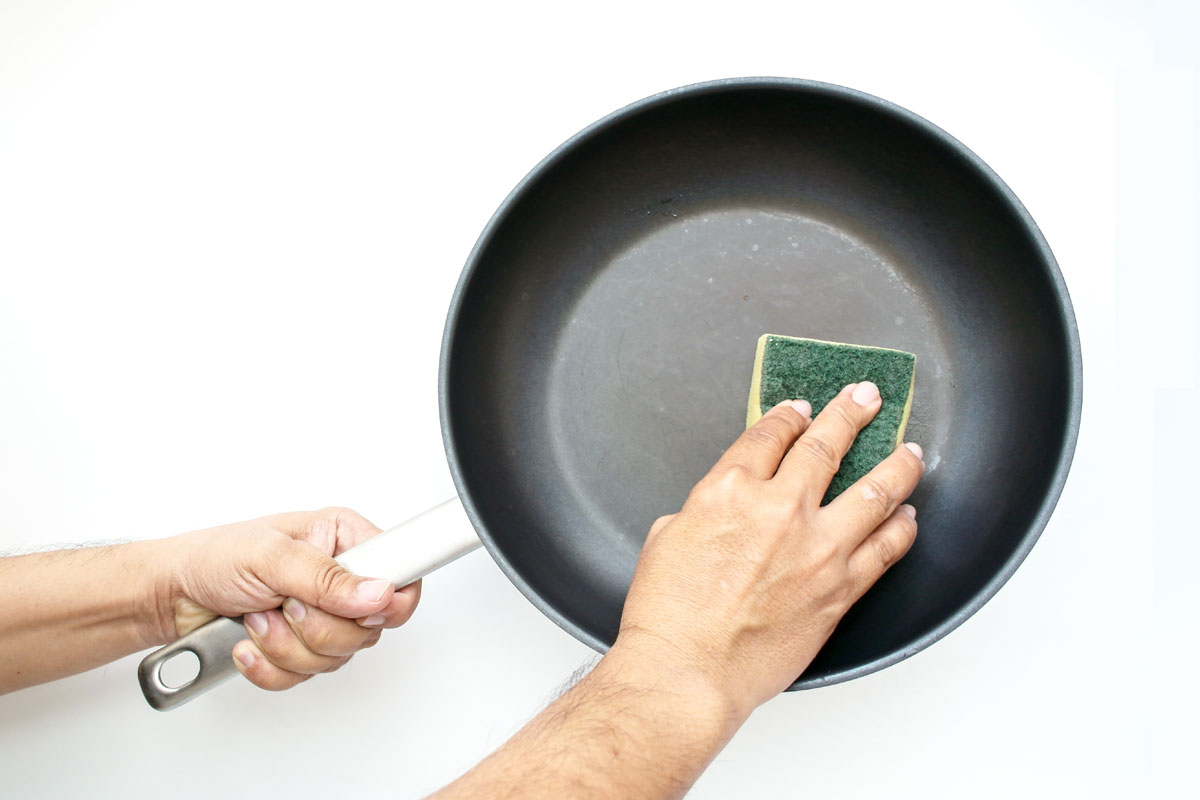 Man cleaning the nonstick pan