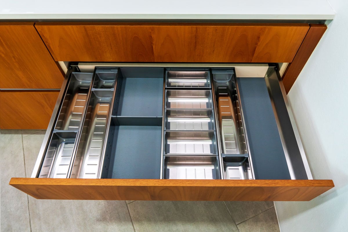 Modern kitchen, Open drawers, Set of cutlery in kitchen drawer. Utensil divider for drawers