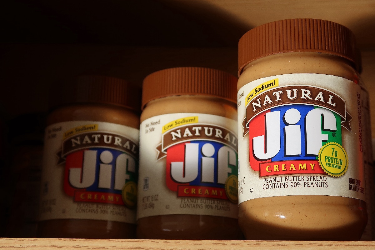 Natural Jif brand peanut butter in a home kitchen cabinet