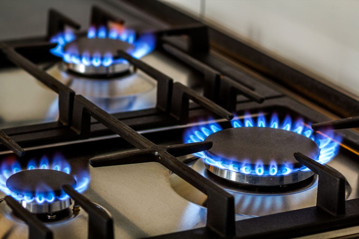 Natural gas burning on kitchen gas stove in the dark