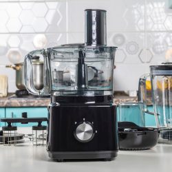 Natural light. black food processor. Near the nozzle for use. In the background is a kitchen for cooking - How Do I Turn On Kitchenaid Food Processor [Quickly & Easily]