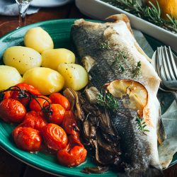 Serve seabass baked with potatoes and tomatoes, What Kind Of Fish Is A Branzino? [& Is It Edible]
