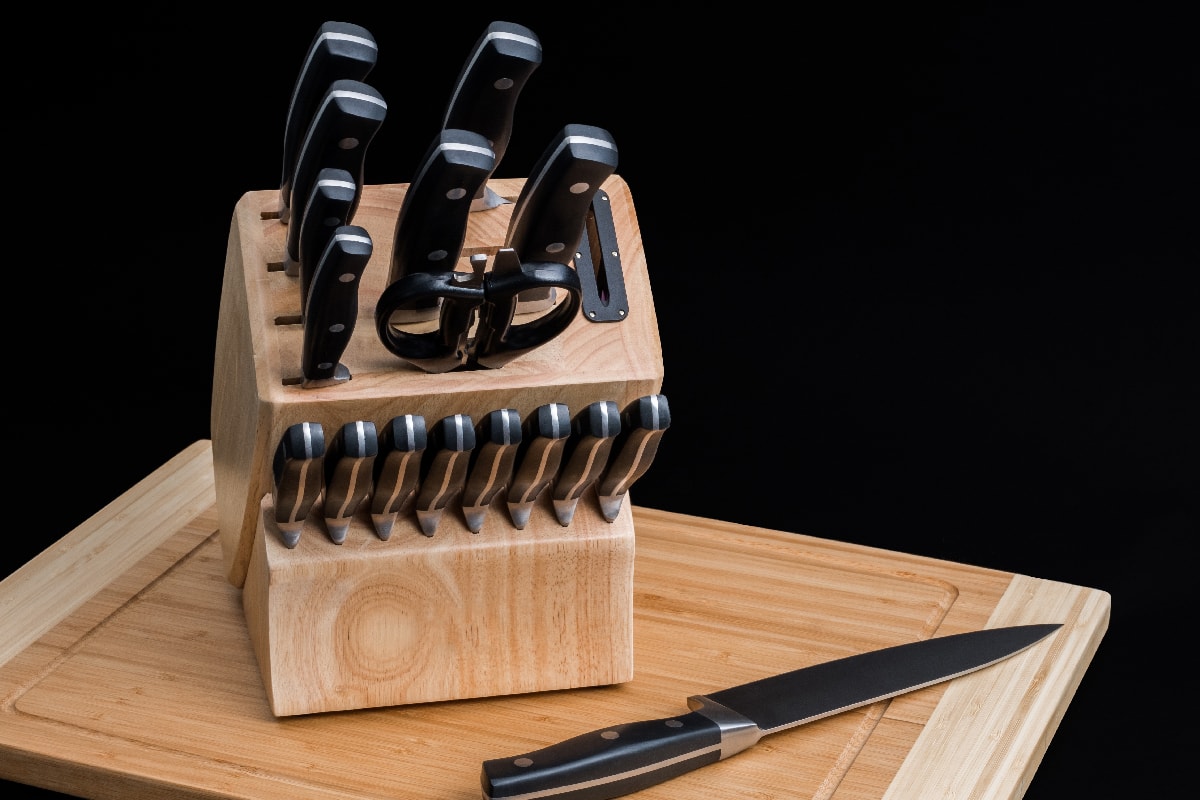Set of kitchen knives on a wooden cutting board