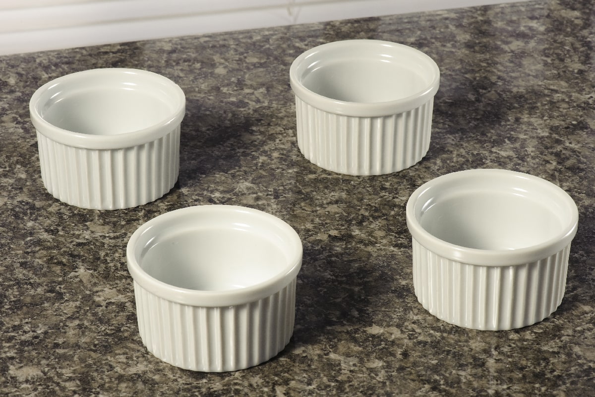 Set with four white ceramic ramekins