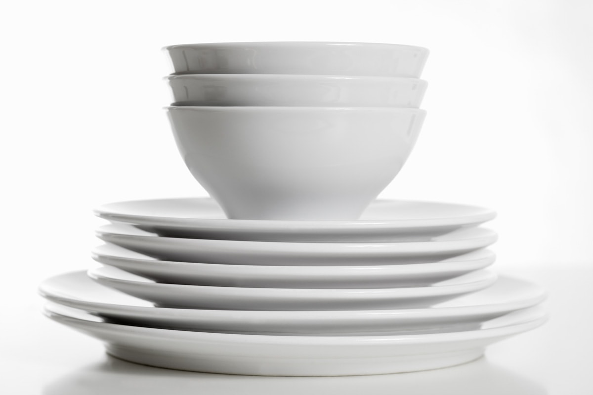 Stack of white plates and bowls.