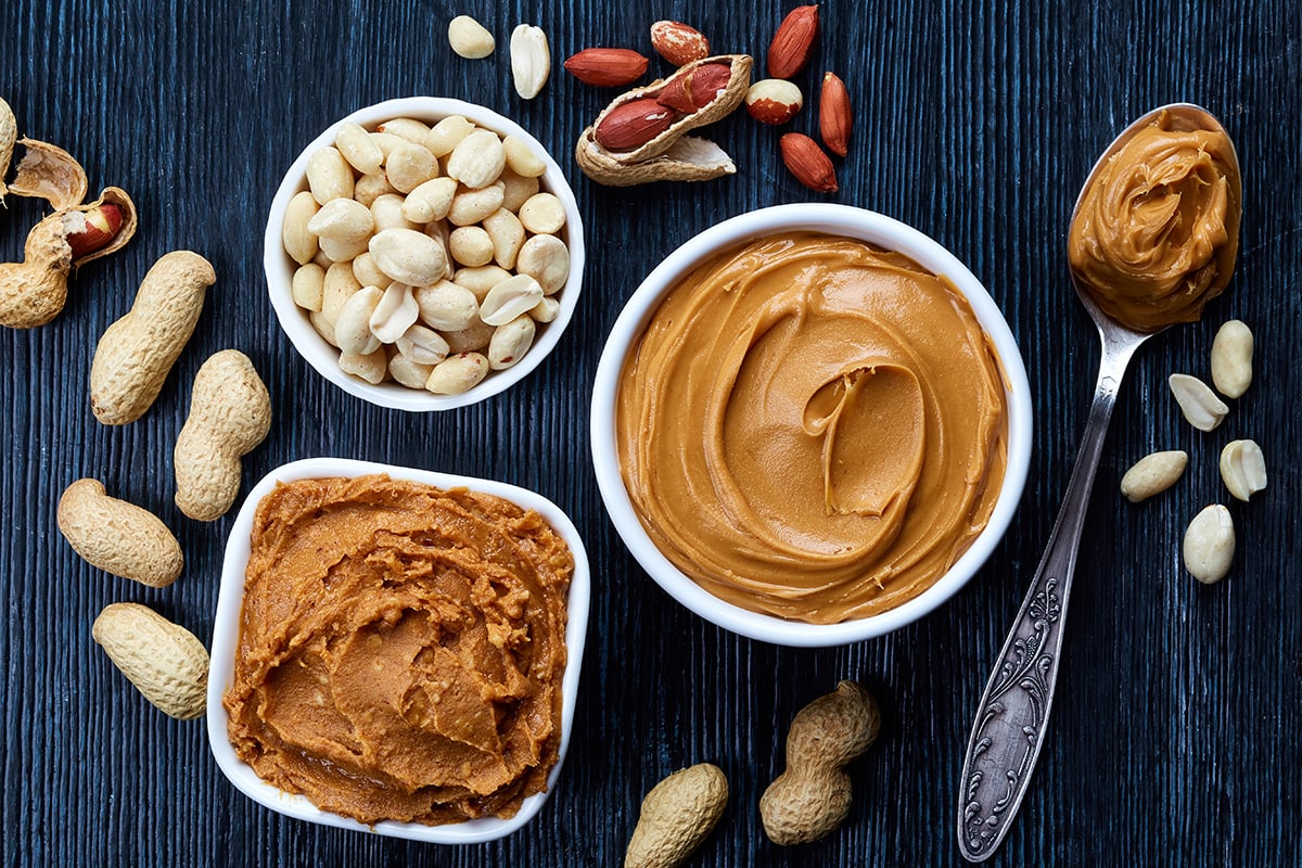 Two bowls of peanut butter and peanuts