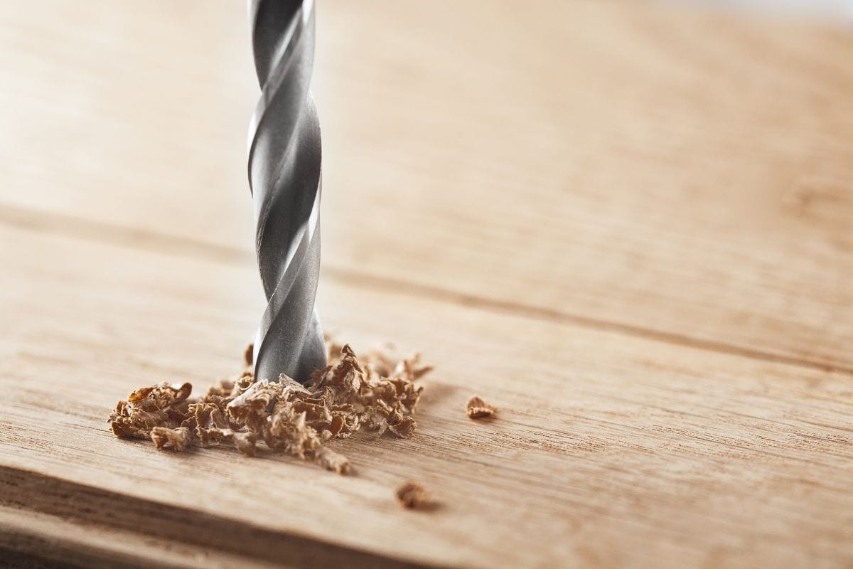 metal drill bit make holes in a wooden oaks plank