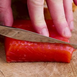 slicing red salted salmon into pieces, the fish is used for cooking and sushi, What Salmon Is Used For Sushi? [These Are The Best Types!]