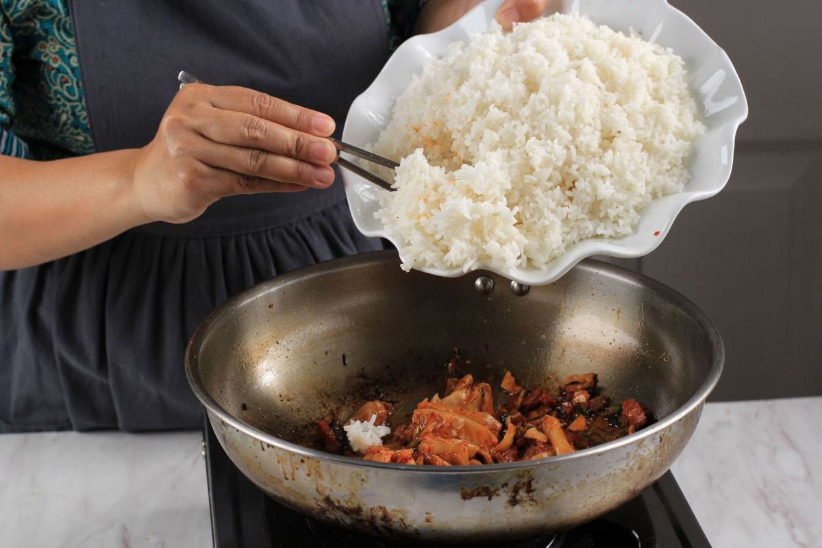 Add White Rice to the Pan with Stir Fry Kimchi, Cooking Process Making Kimchi Fried Rice in the Kitchen