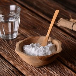 A baking soda into the bowl with wooden spoon, How To Make Baking Soda Hard