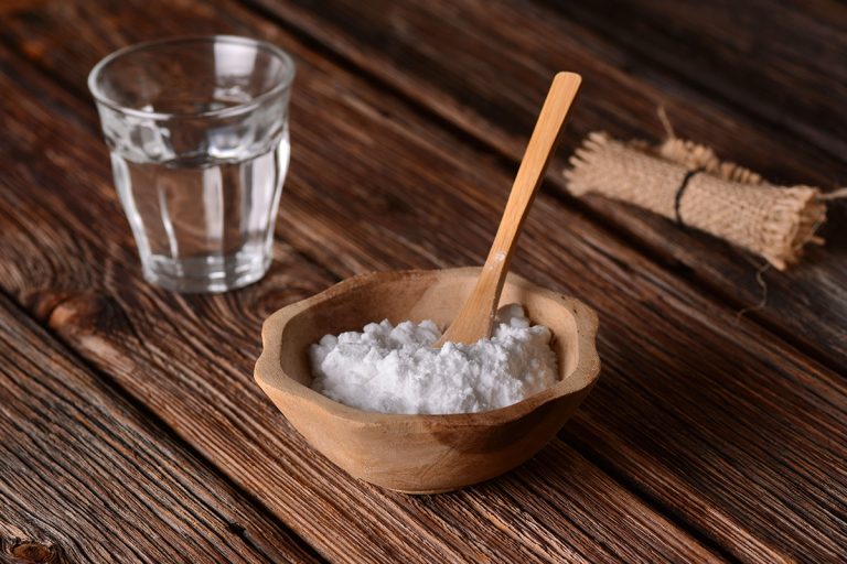 A baking soda into the bowl with wooden spoon, How To Make Baking Soda Hard
