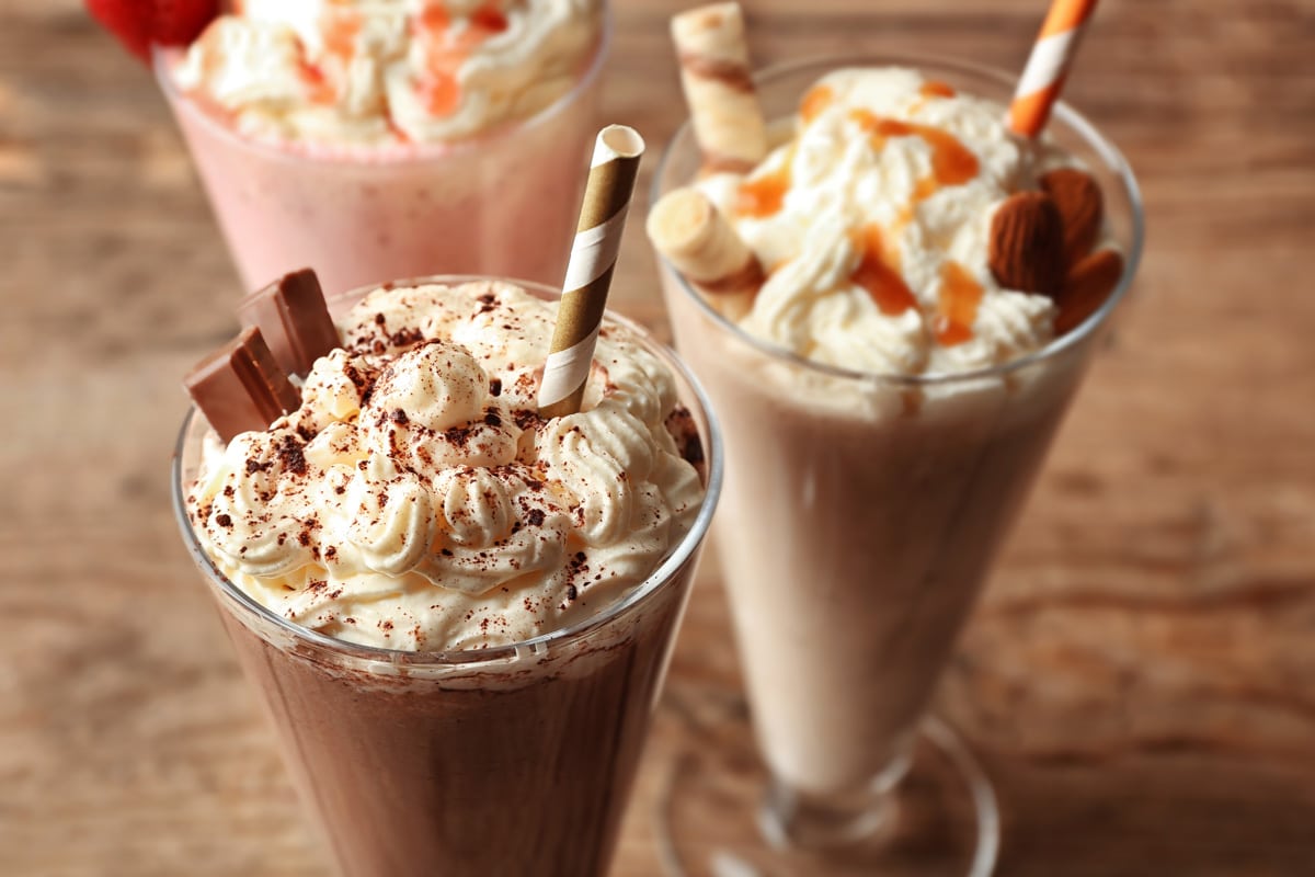 Chocolate milkshakes drizzled with whipcream and crushed chocolate