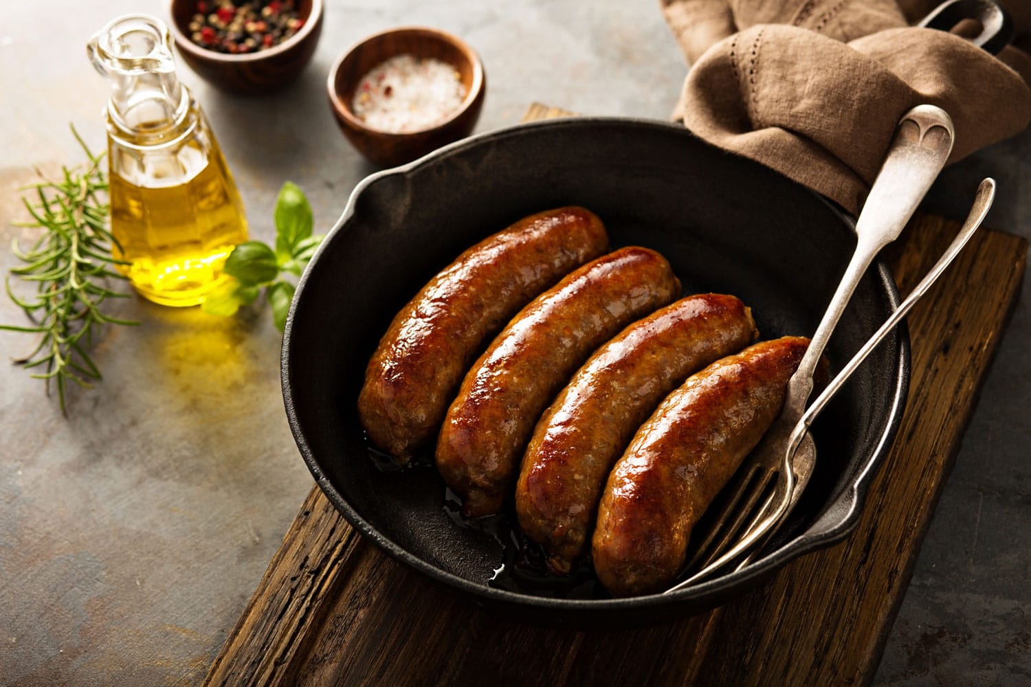 Homemade sausage with italian herbs and cheese in a cast iron pan 