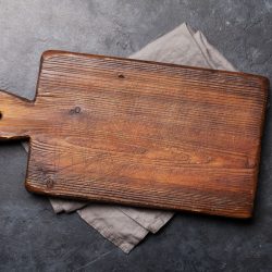 Old cutting board over towel on stone kitchen table. Top view flat lay, Why Is My Wooden Cutting Board Splintering?