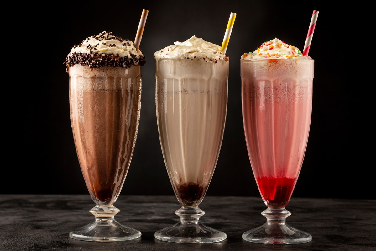 Three different flavors of milkshakes prepared on the table