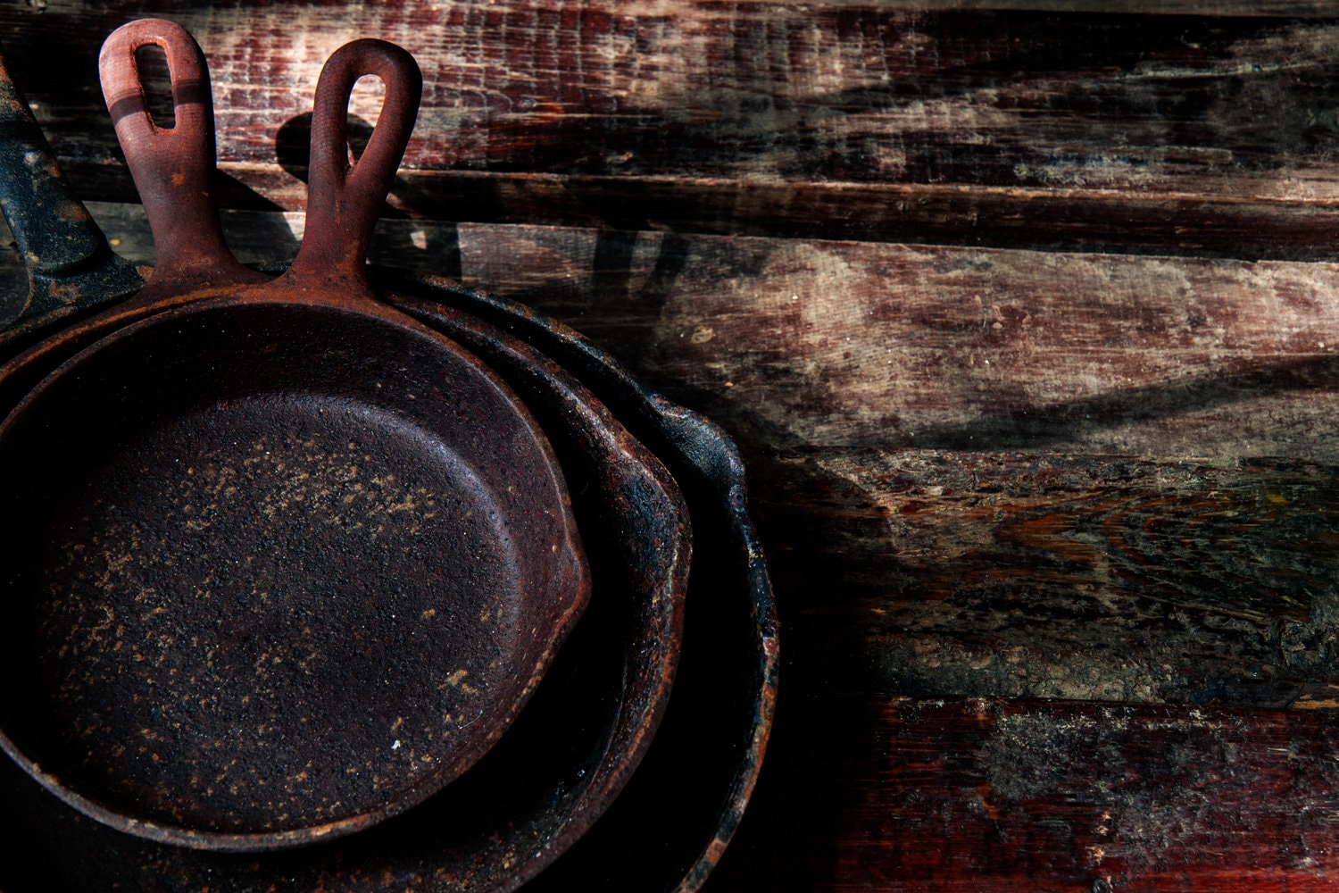 cast iron skillets staked 