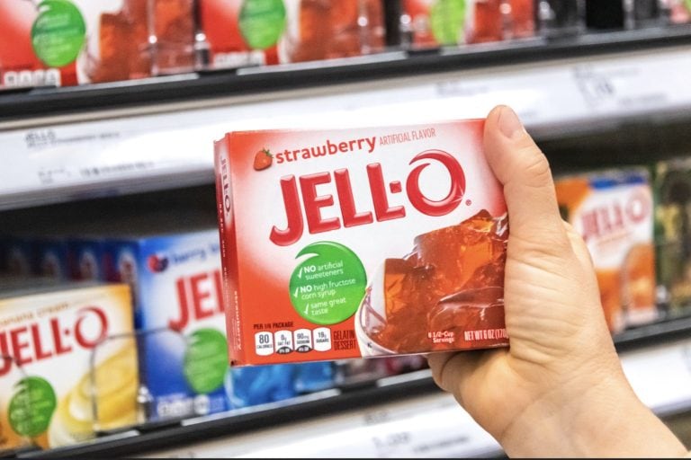 shoppers hand holding a box of Jell-o strawberry gelatin dessert at a supermarket aisle, Can You Make Jell-O Without Boiling Water?
