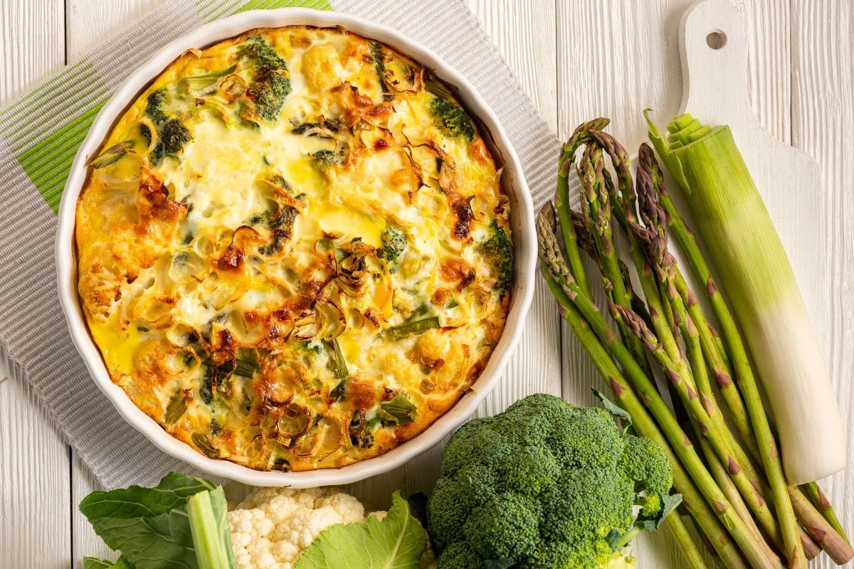 Broccoli, cauliflower and asparagus casserole with eggs and cheese, keto diet dish.
