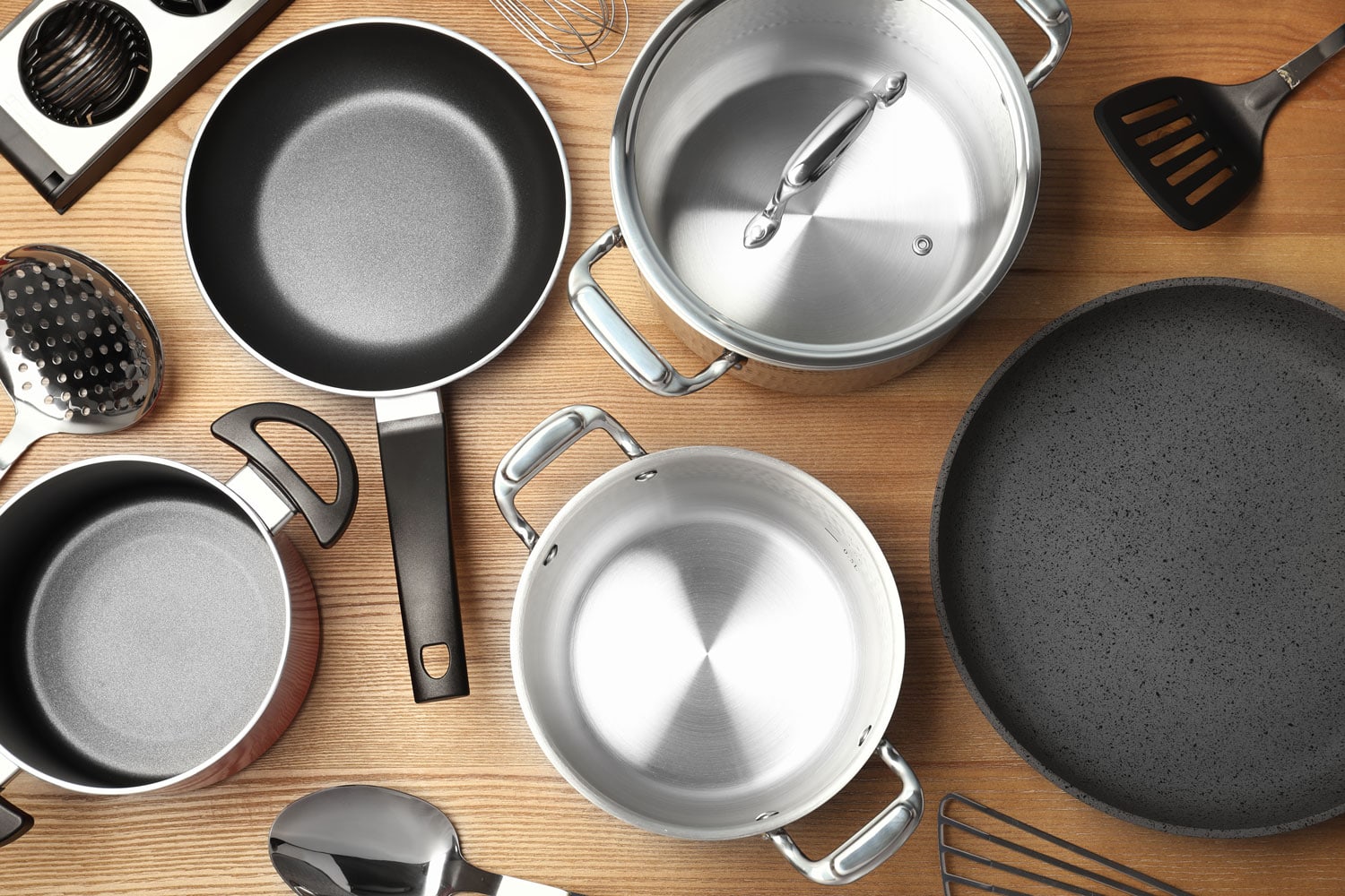 Flat lay composition with clean cookware on wooden background 