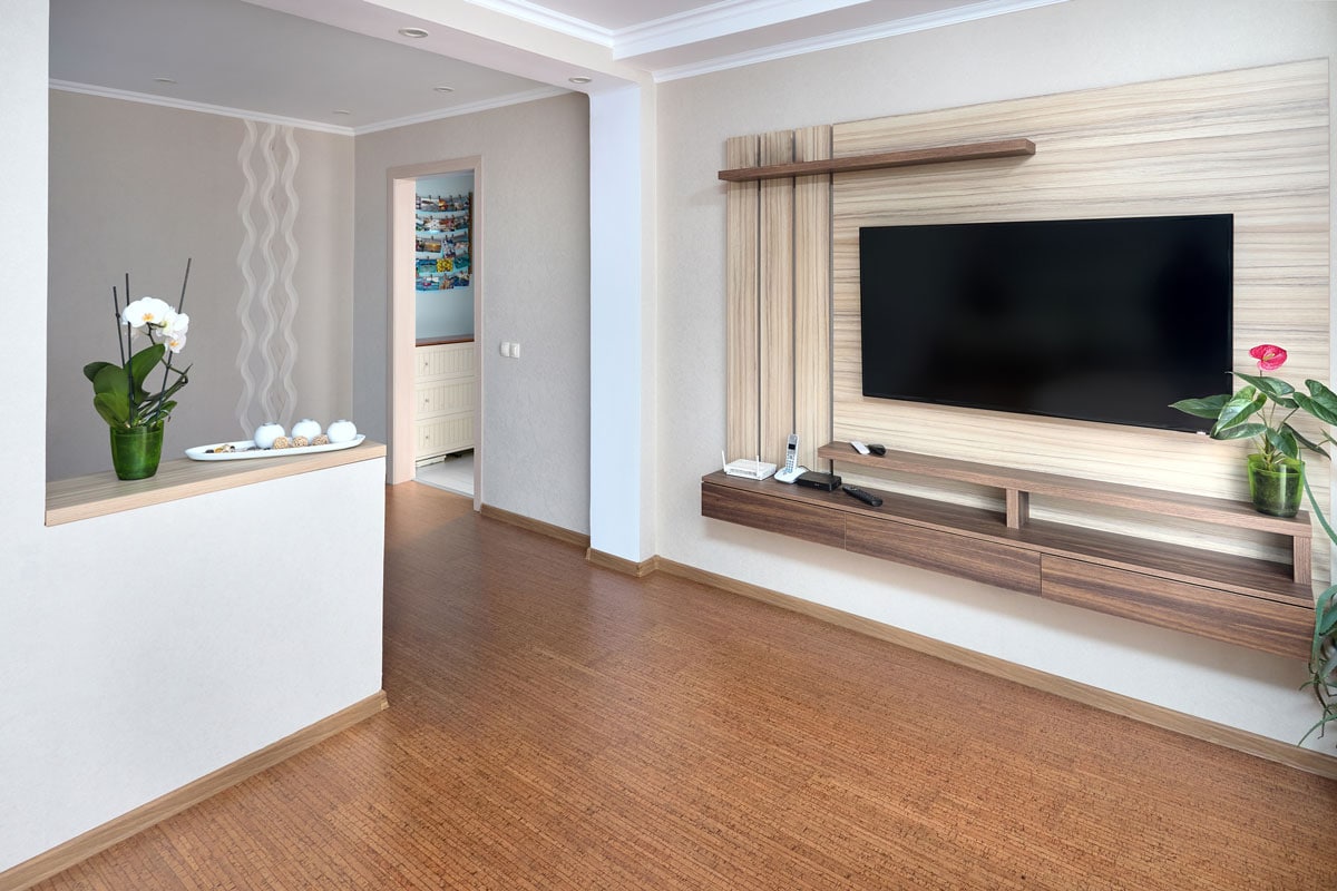 Modern apartment living room with large TV over wooden cabinet Orchid