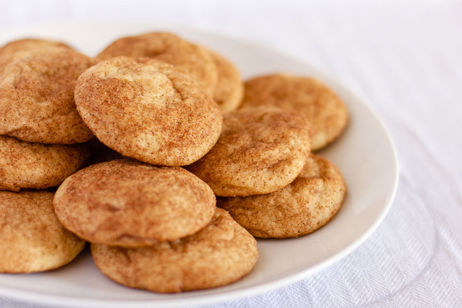 Plate of snickerdoodle cookies with a white napkin background 