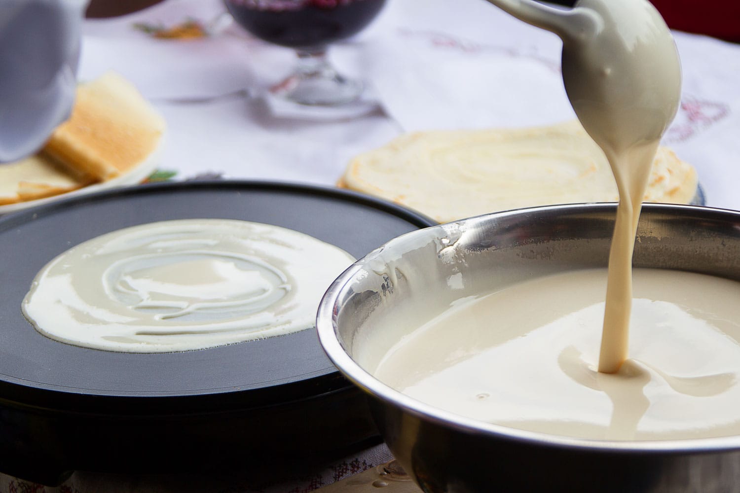 Pour batter for pancakes into a frying pan 