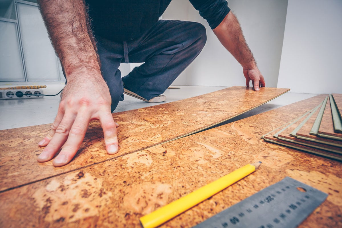 Professional removing the cork flooring panels
