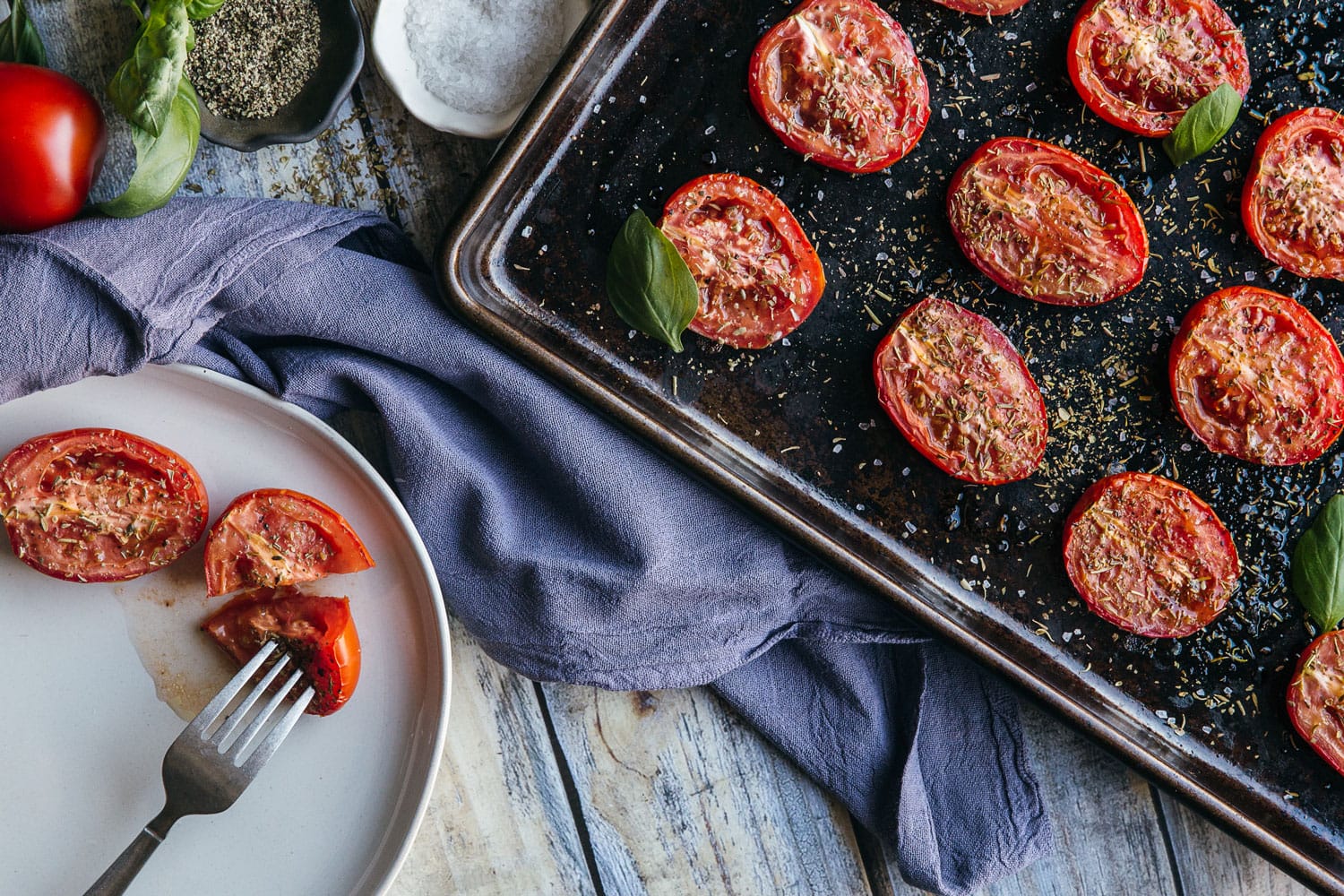 Roasted Roma Tomatoes on Baking Sheet with Italian spices 