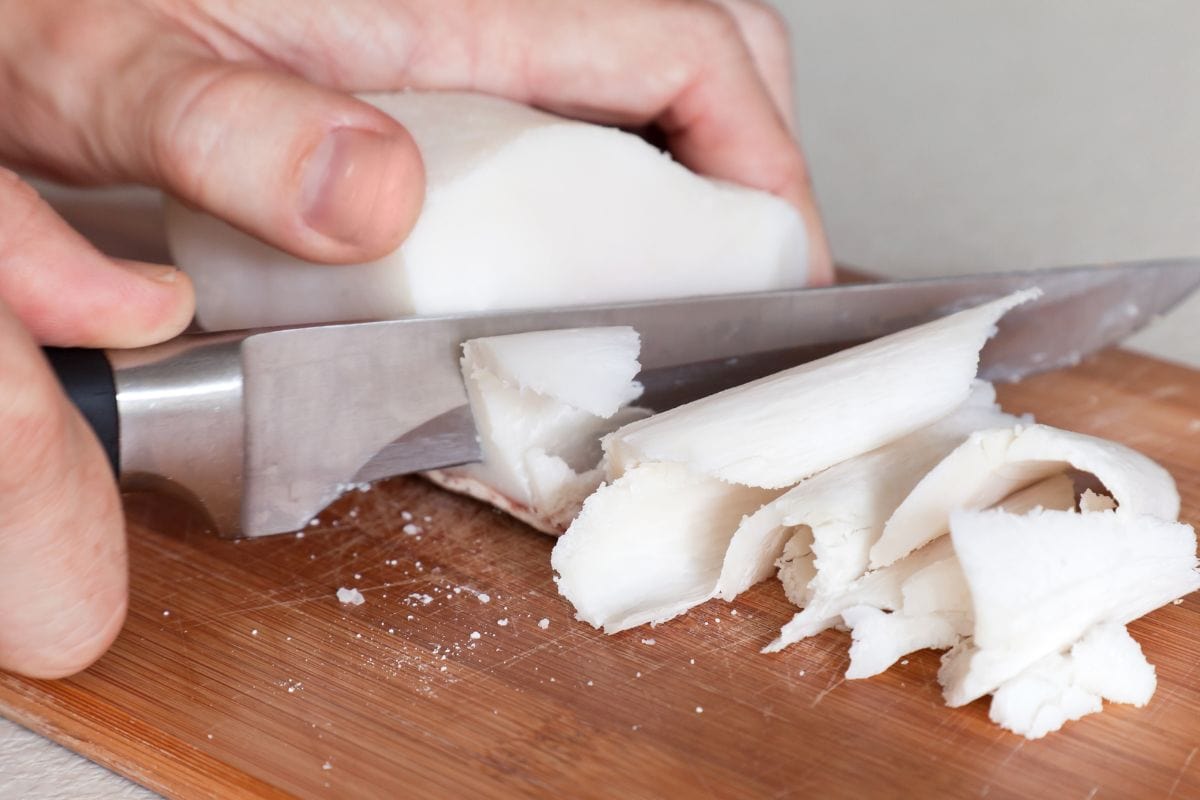 Salted white pork fat slicing on a cutting board