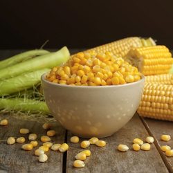 Bowl with corn seeds and ripe corn cobs on wooden table, Does Corn Need To Be Refrigerated