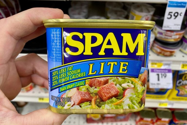 Man holding a small can of Spam lite, Spam Lite Vs Spam What's The Difference
