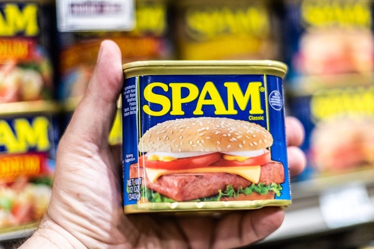 Shoppers hand holding a can of SPAM brand canned meat, How To Make Spam Less Salty [Four Ways To Try!]