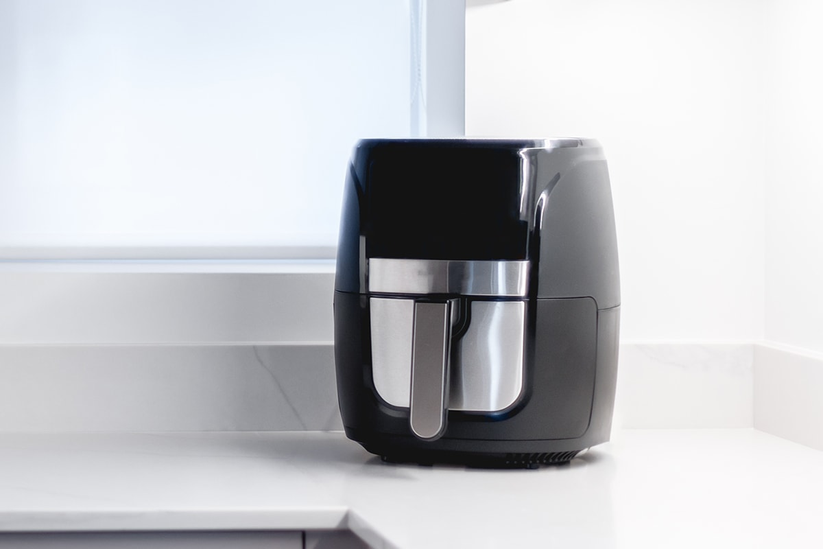 Trendy kitchen gadget air fryer on a small countertop