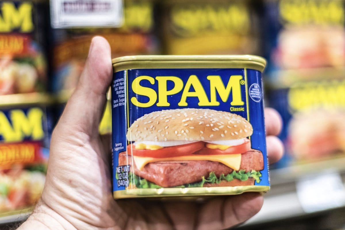 Shoppers hand holding a can of SPAM brand canned meat