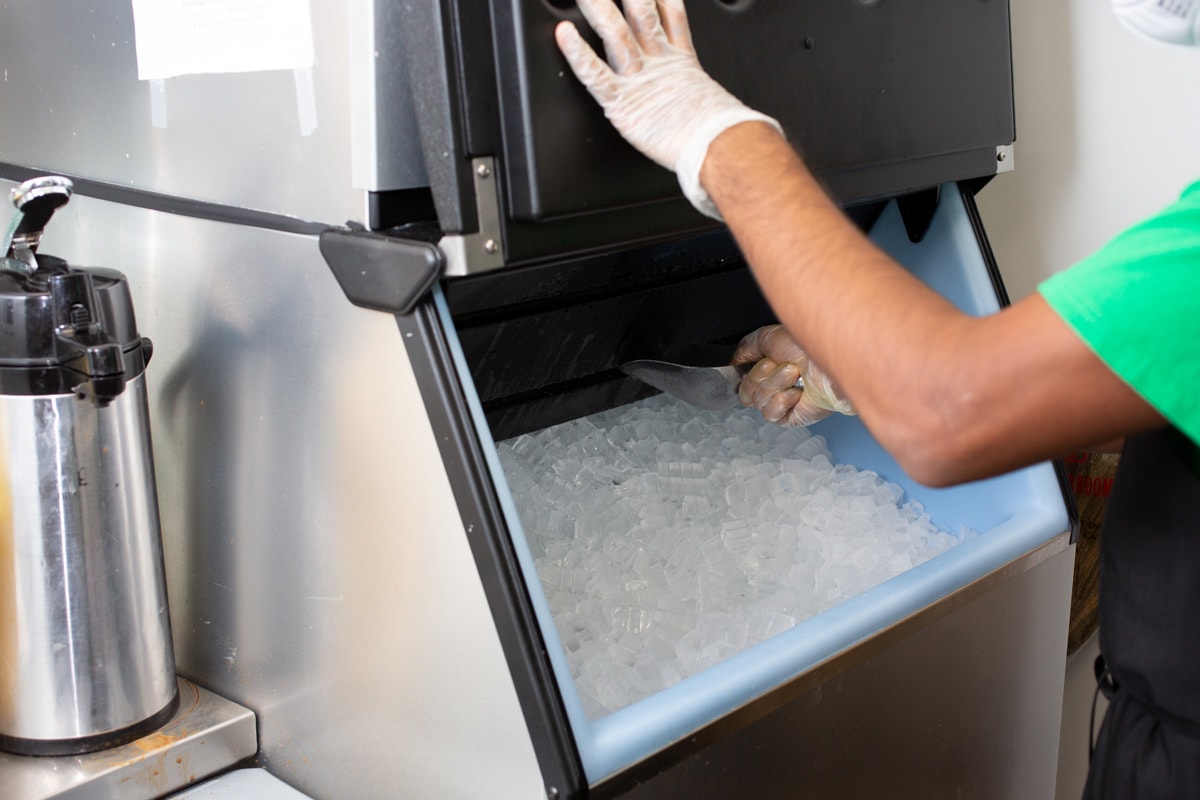 A man doing operating the ice maker
