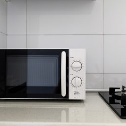 Modern kitchen interior with electric and microwave oven, Panasonic Vs. LG Microwave: Pros, Cons, & Differences