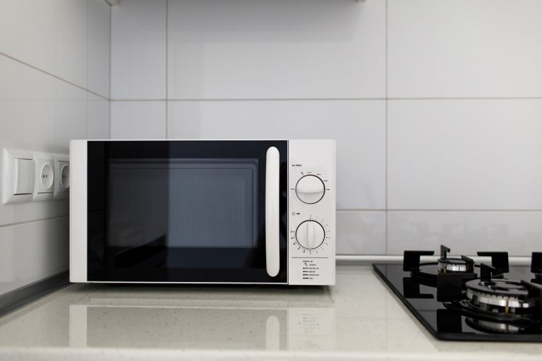 Modern kitchen interior with electric and microwave oven, Panasonic Vs. LG Microwave: Pros, Cons, & Differences