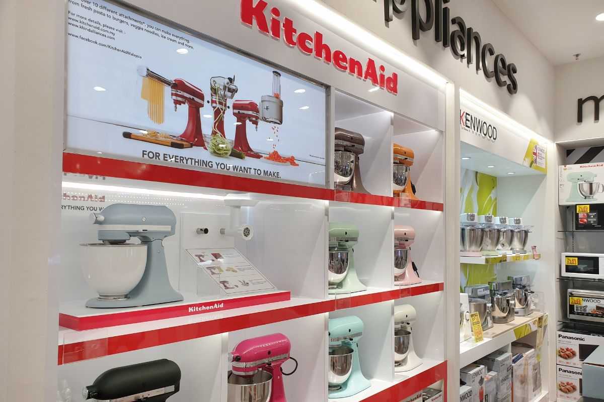 View of modern KitchenAid stand mixers on store shelf. KitchenAid is an American home appliance brand owned by Whirlpool Corporation.