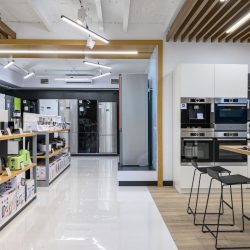 showroom of domestic appliance store with equipment mostly from Bosch brand such as ovens, kettlles, meat grinders and toasters. - Kitchenaid Vs Cafe Appliances: Pros, Cons, & Differences
