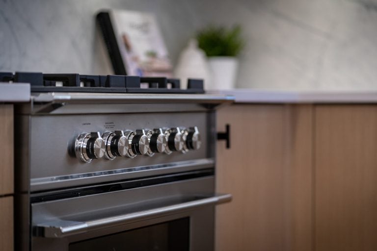 A selective focus of gas range in the kitchen, ZLINE vs. KitchenAid Range: Pros, Cons, & Differences