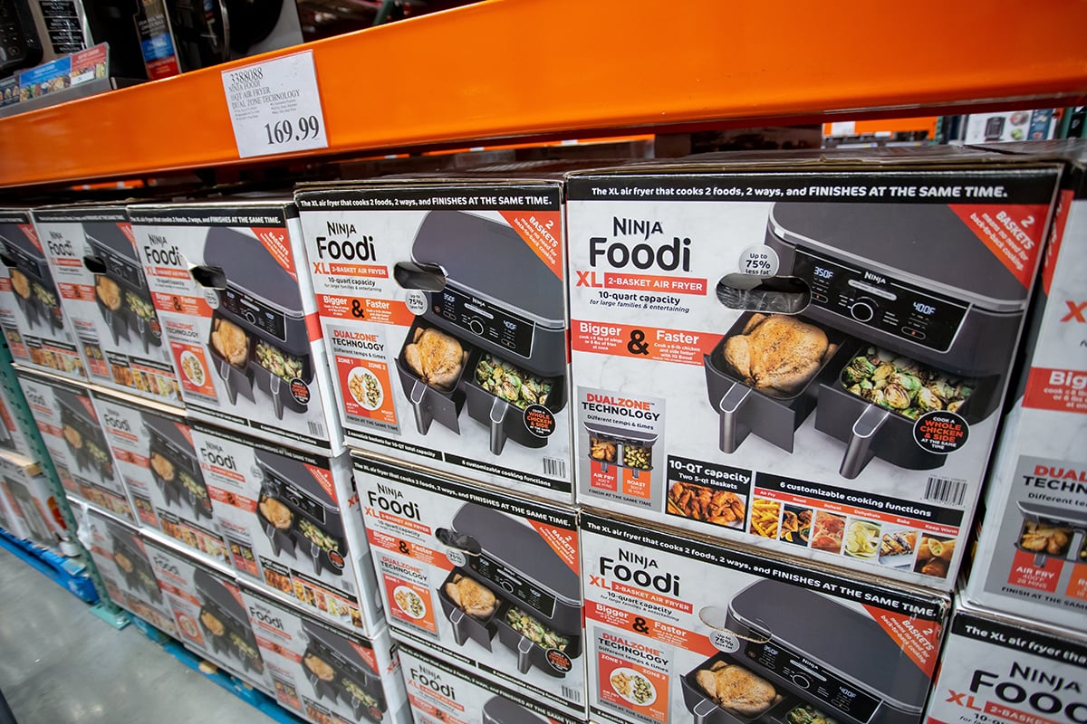 A view of several cases of Ninja Foodi XL 2-basket air fryer appliances, on display at a local big box grocery store.