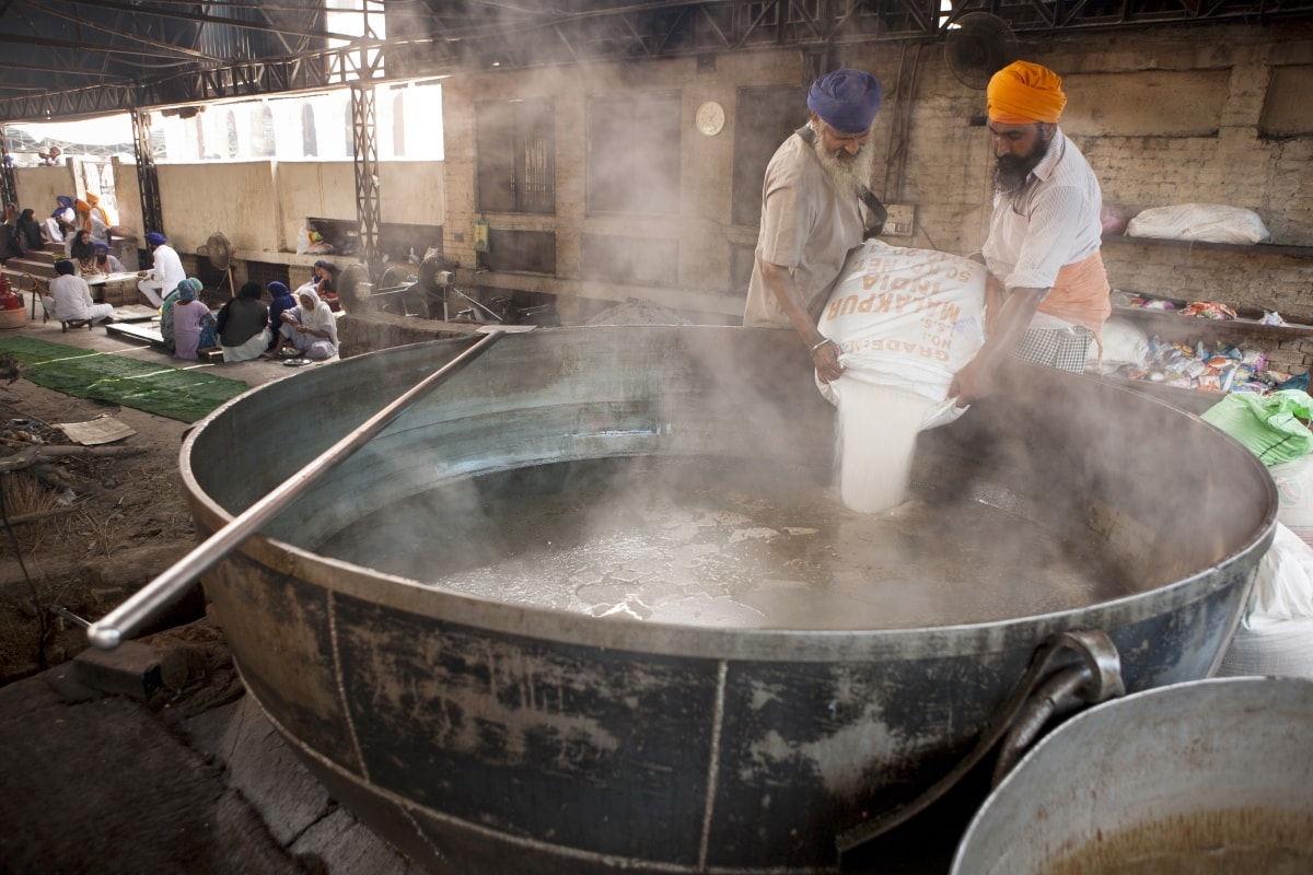 Amritsar, India - SEPTEMBER 16 Cooks preparing food portion for pilgrims. The Kitchen at Golden Temple Feeds up to 100,000 People a Day for Free on SEPTEMBER 16, 2016 in Harmandir Sahib, Amritsar.