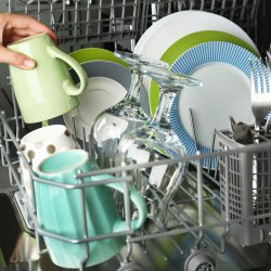 Open dishwasher with clean utensils in it, What Is The Difference Between Dishwasher Safe And Dishwasher Proof?